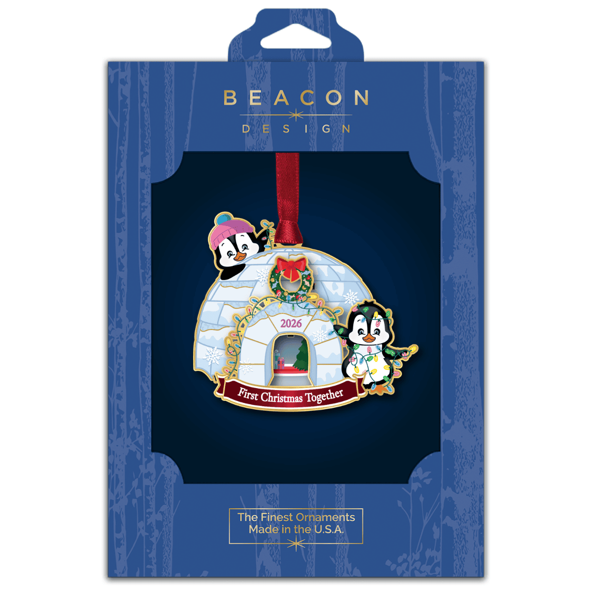 Ornament featuring a decorated igloo with two penguins, holiday lights, and the message “First Christmas Together 2026,” displayed in Beacon Design retail packaging