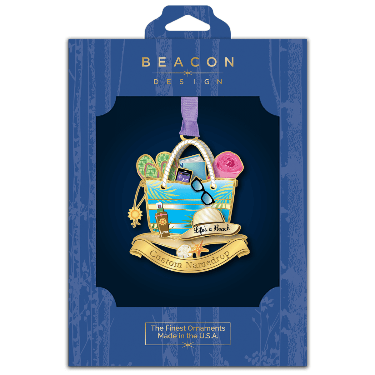 Custom namedrop ornament featuring a beach tote filled with summer essentials, including flip-flops, sunglasses, a book, sunscreen, and a beach towel, displayed in Beacon Design retail packaging