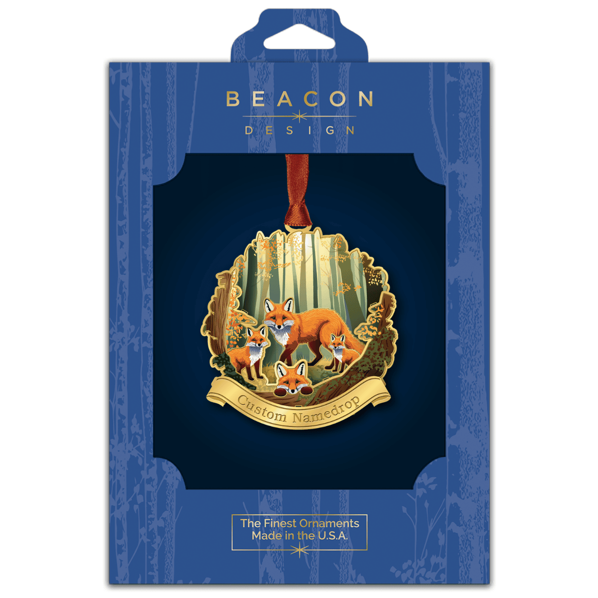 Custom namedrop ornament featuring a fox family in a woodland forest scene, displayed in Beacon Design retail packaging