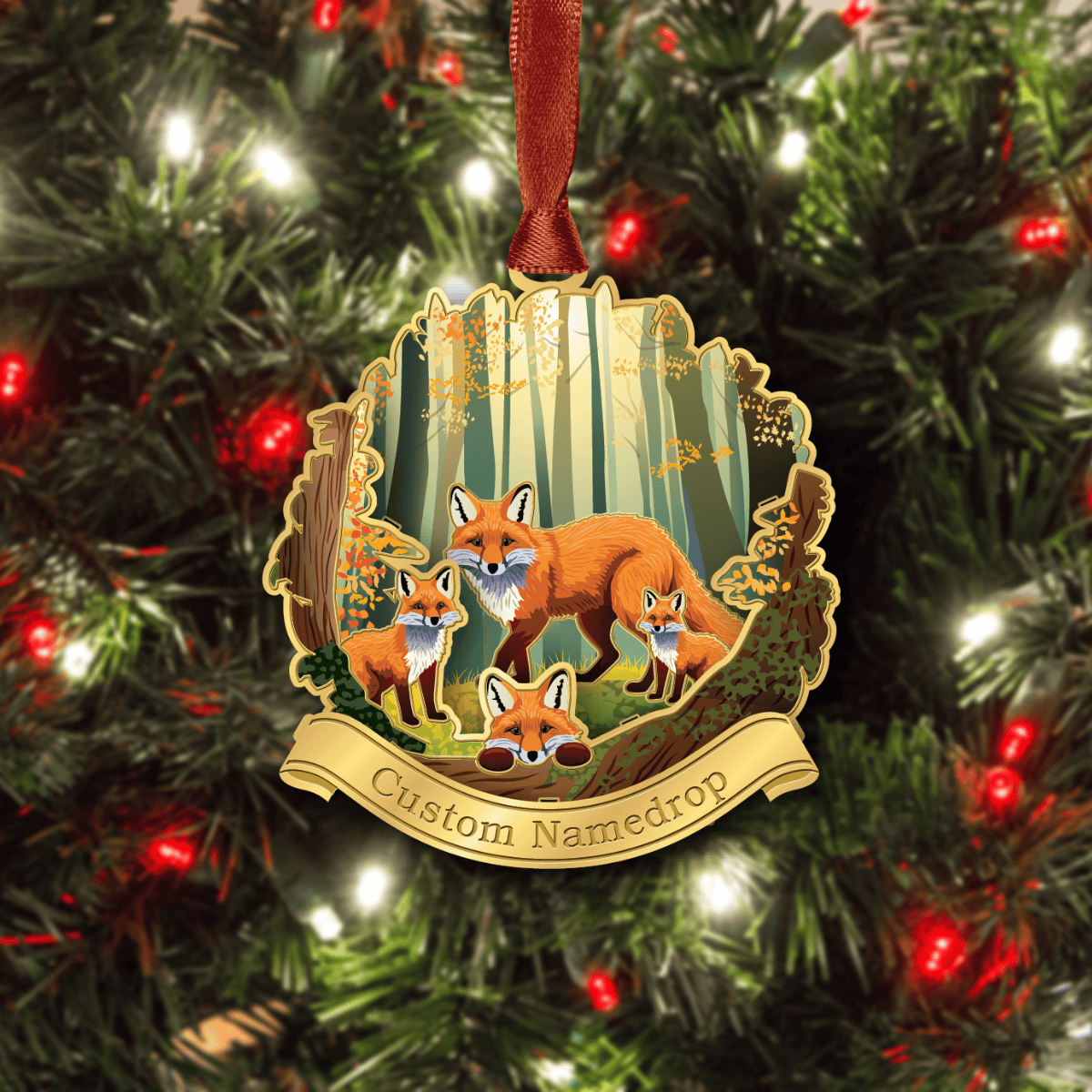 Custom namedrop ornament featuring a fox family in a woodland forest scene, displayed on a decorated Christmas tree