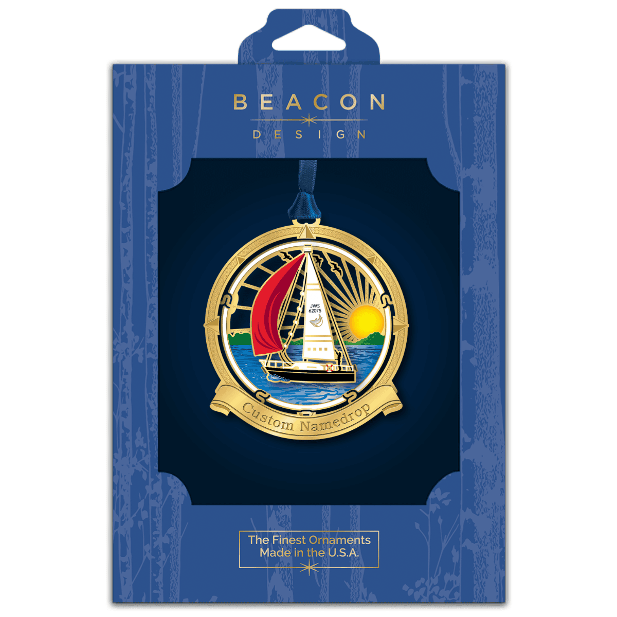 Custom namedrop ornament featuring a sailboat on open water at sunset, framed by a nautical compass design, displayed in Beacon Design retail packaging