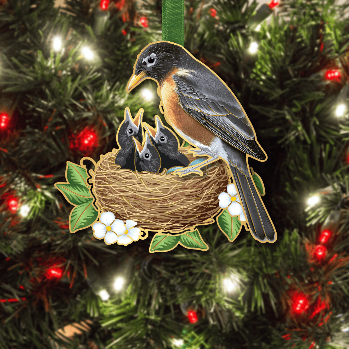 Custom ornament featuring an American robin perched on a nest with three baby birds, surrounded by leaves and white flowers, displayed on a decorated Christmas tree