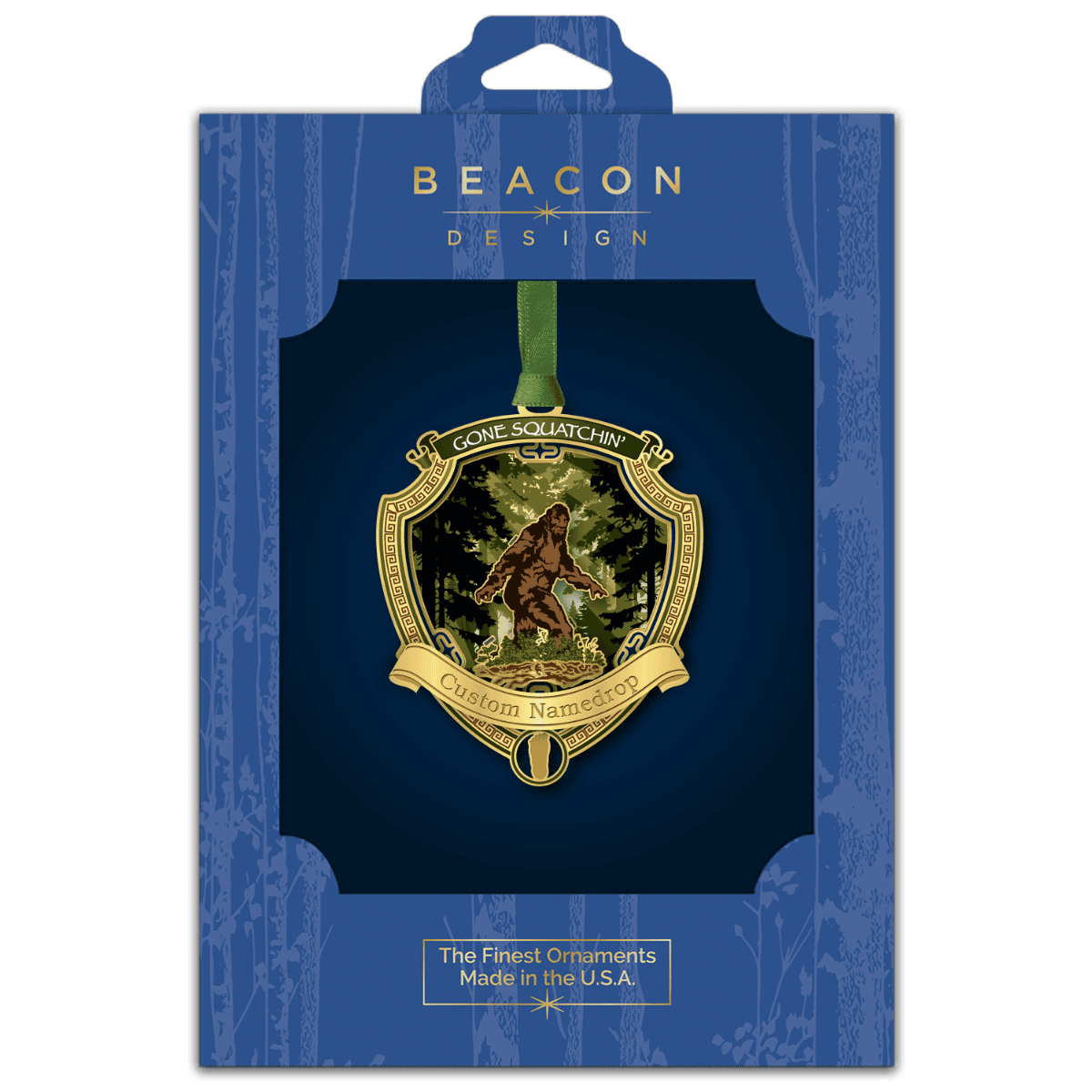 Custom namedrop ornament featuring Bigfoot walking through a forest with the phrase “Gone Squatchin’,” displayed in Beacon Design retail packaging