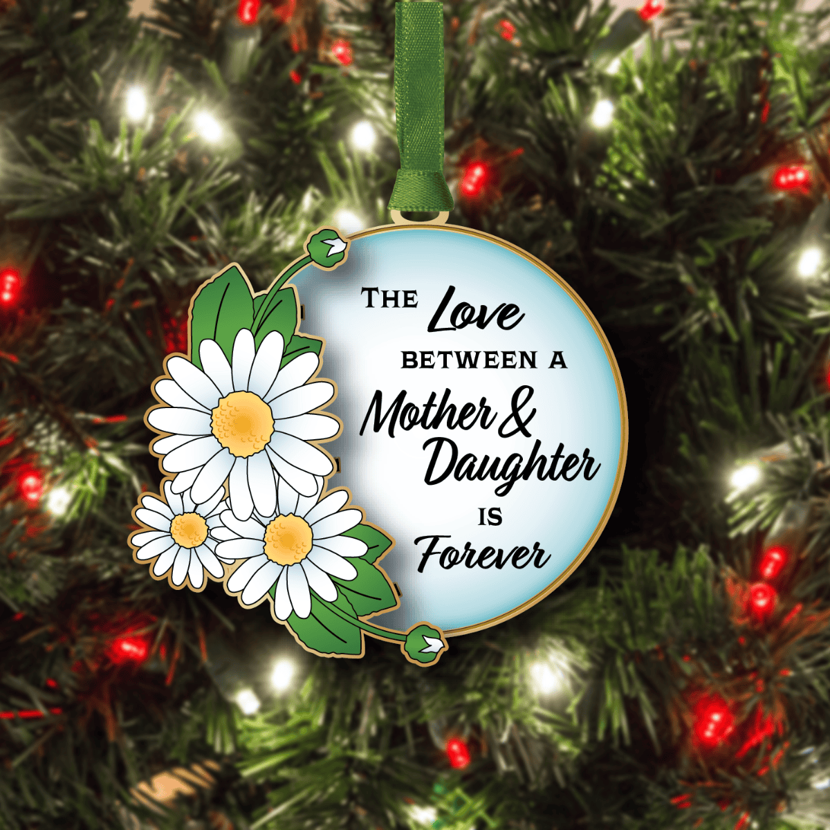 Ornament featuring daisies and leaves with the message “The Love Between a Mother & Daughter Is Forever,” displayed on a decorated Christmas tree