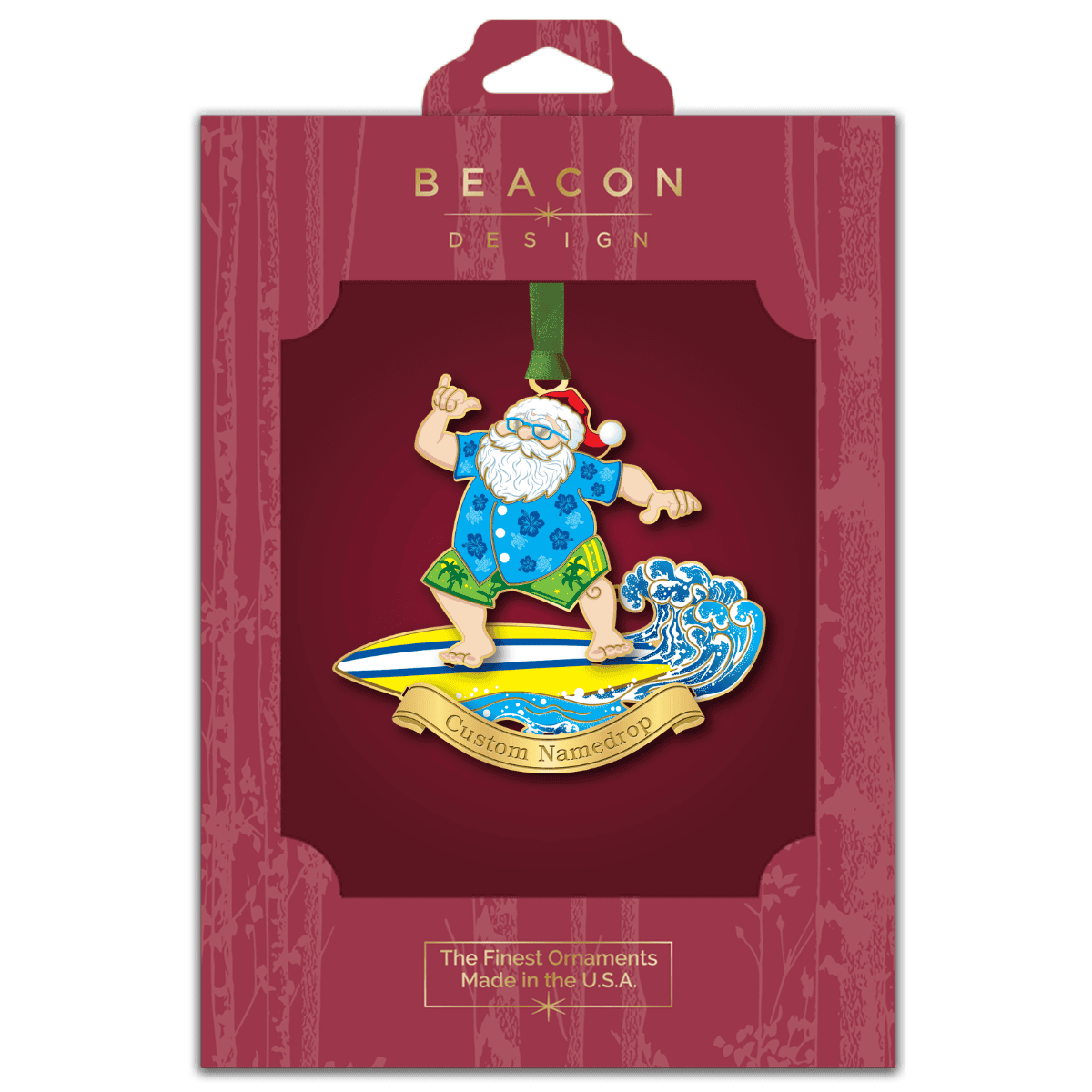 Custom namedrop ornament featuring Santa Claus surfing a wave on a surfboard displayed in Beacon Design retail packaging