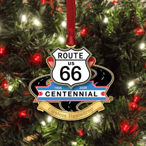 Route 66 Centennial namedrop ornament hanging on a decorated Christmas tree