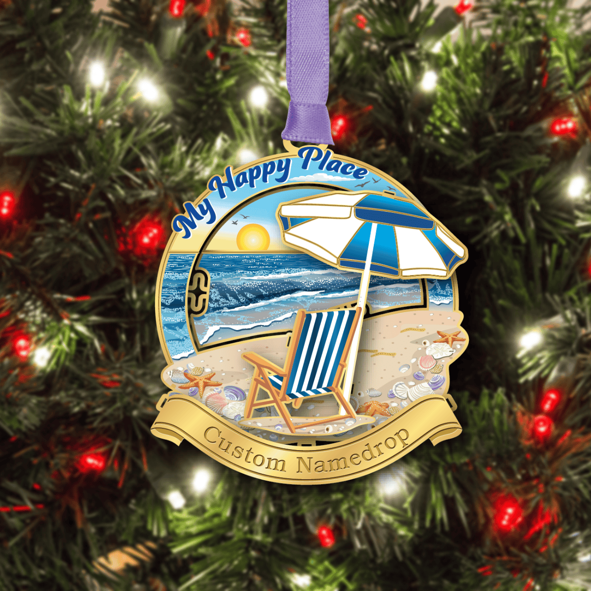 Custom namedrop ornament featuring a beach scene with a striped chair and umbrella overlooking the ocean at sunset, with the phrase “My Happy Place,” displayed on a decorated Christmas tree