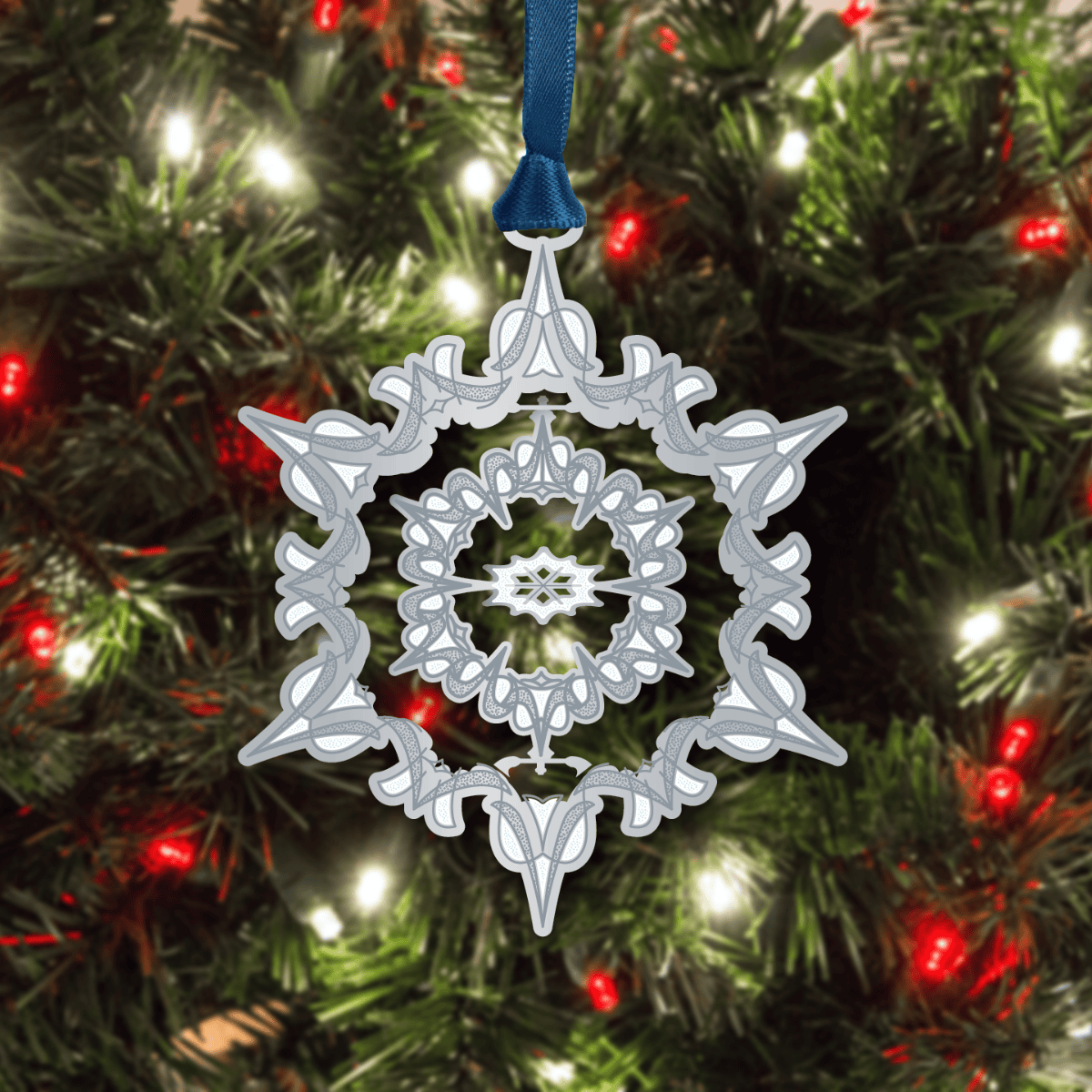 Snowflake ornament featuring an intricate snowflake design displayed on a decorated Christmas tree