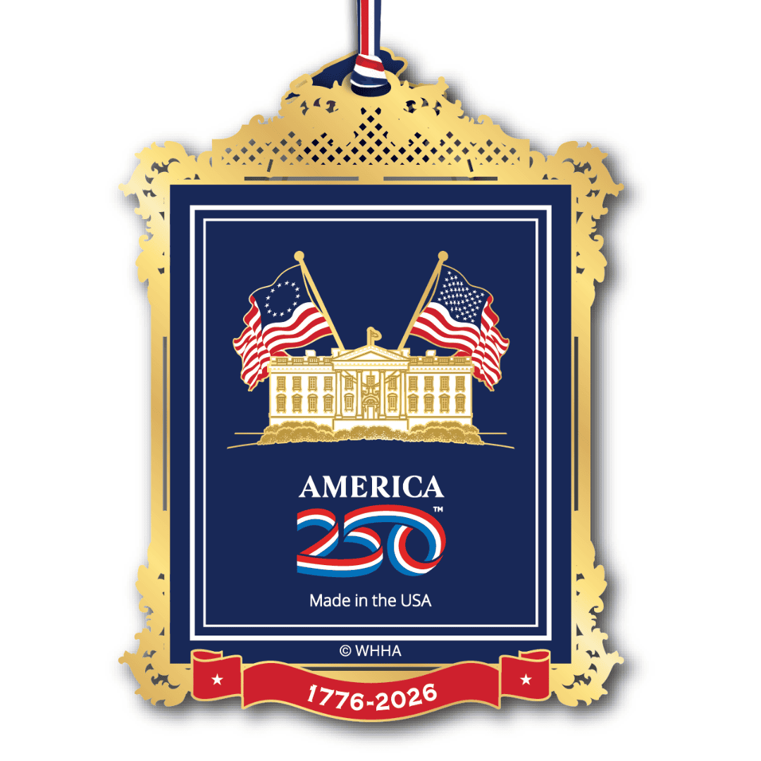 White House Historical Assocation's ornament featuring the White House with two American flags, an ornate gold frame, and the America 250 logo with the years 1776–2026