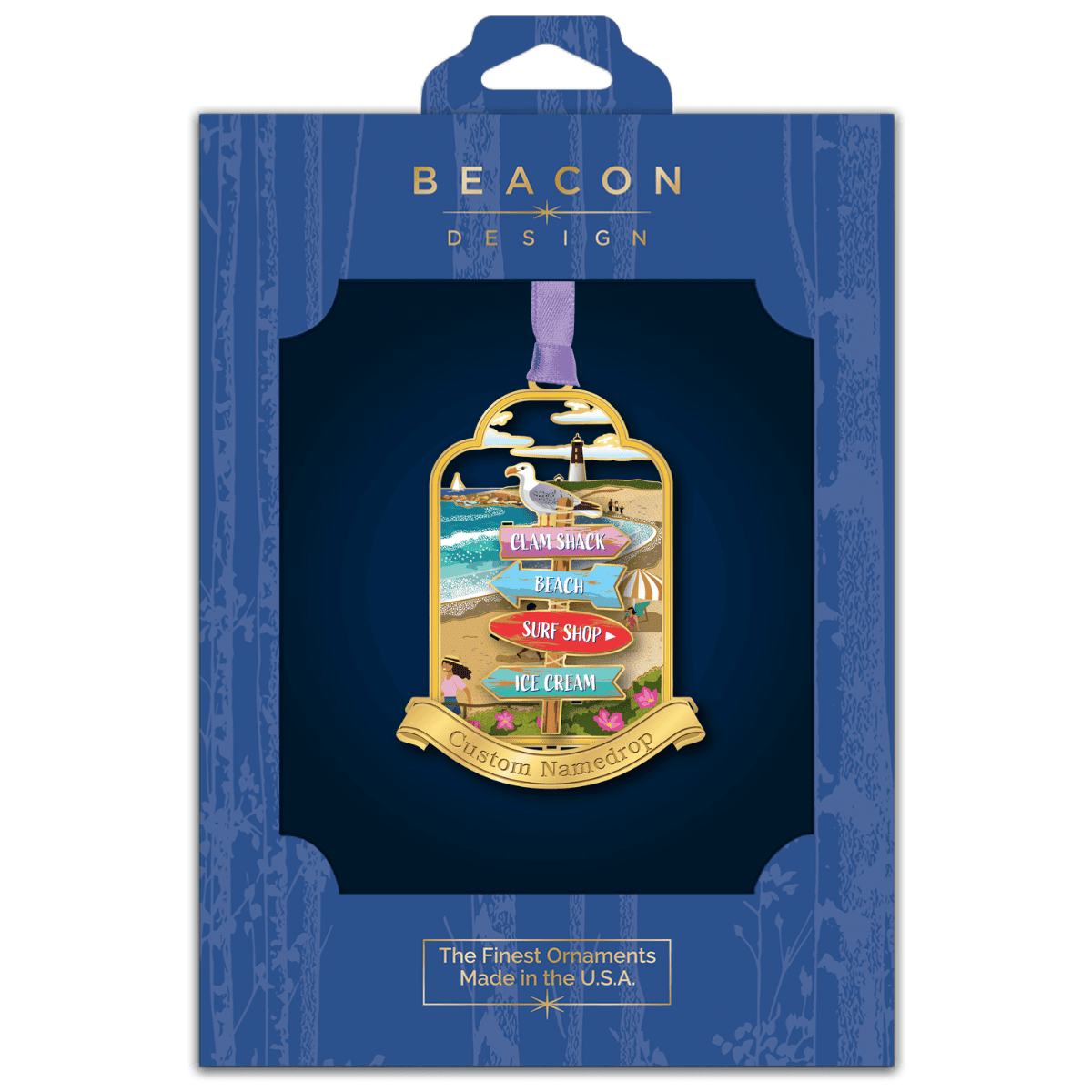 Custom beach-themed nameddrop ornament featuring a seagull, lighthouse, and directional signs for coastal attractions displayed in Beacon Design retail packaging
