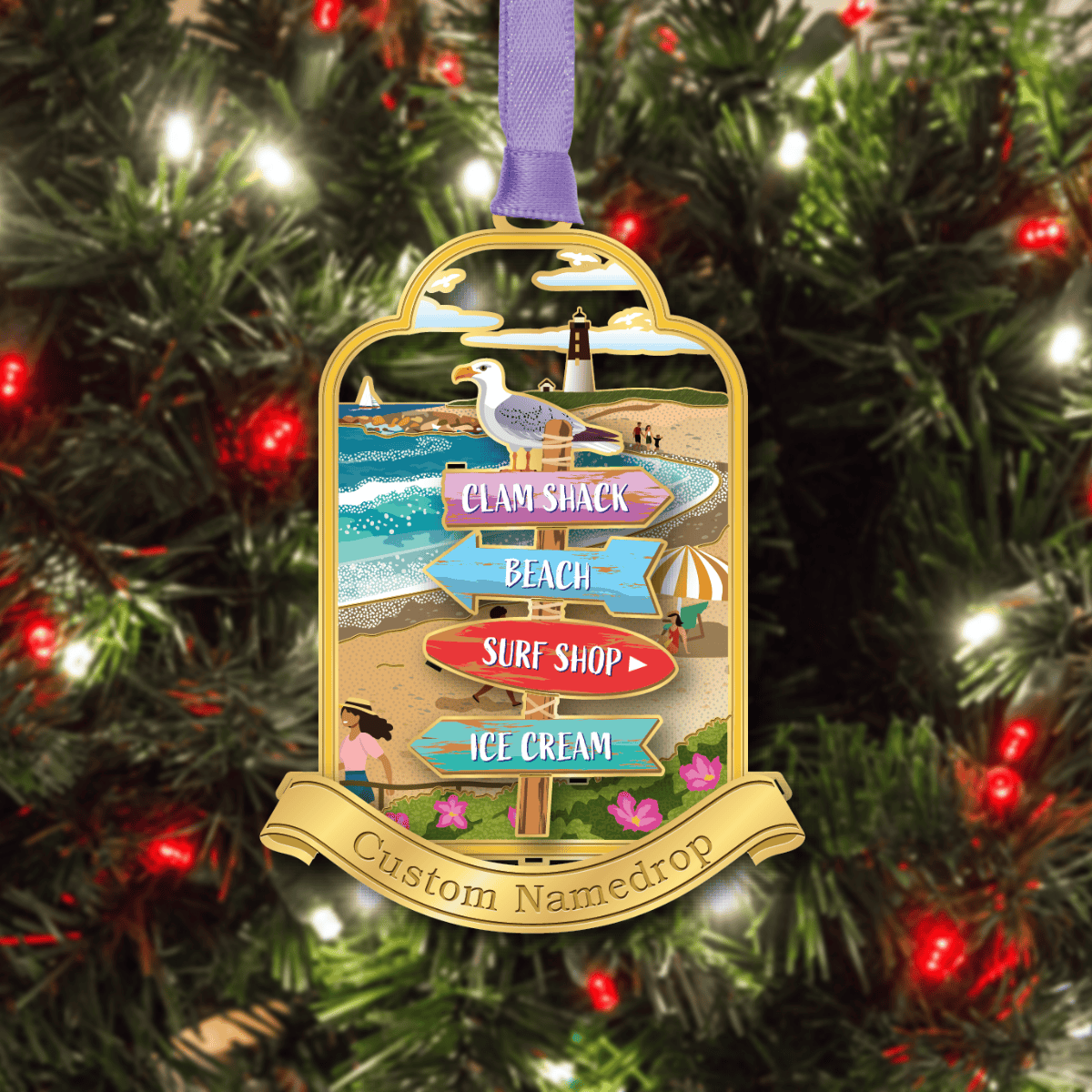 Custom beach-themed namedrop ornament featuring a seagull, lighthouse, and directional signs, displayed on a decorated Christmas tree